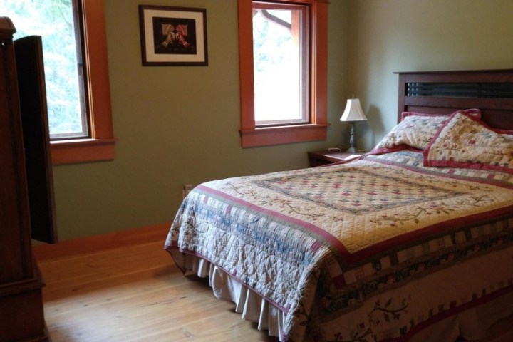 a bedroom with a bed and desk in a room